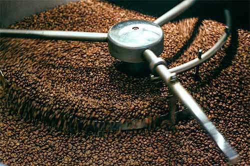 An image of coffee beans inside a roaster. This is at the top of Bean Merchant's blog for finding the best coffee beans in New Zealand.